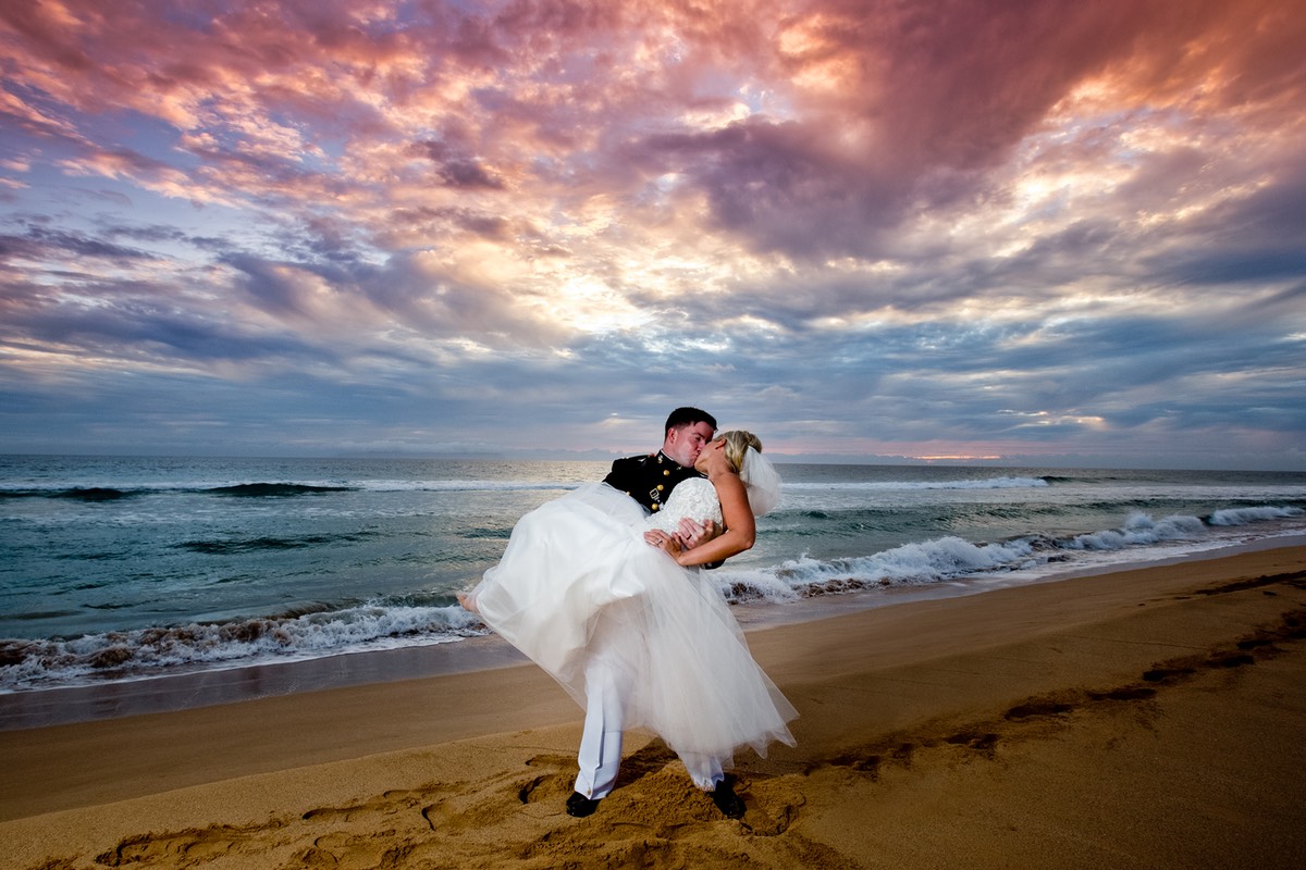 Blazing sunset bride's kiss by Kauai wedding photographer David Marsh