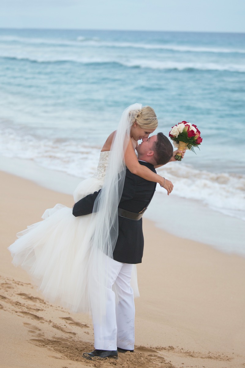 Smooch bride and groom on Kauai beach