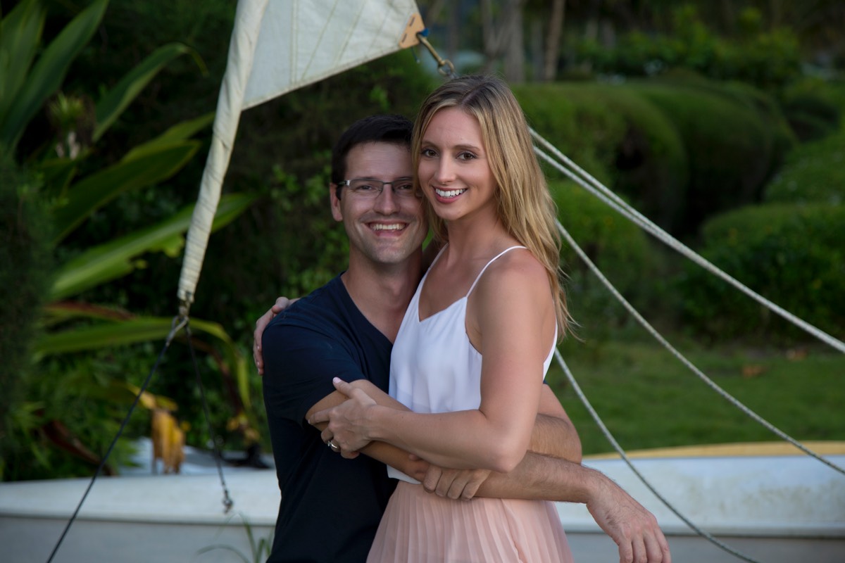 Kauai newlyweds cuddle up by outrigger canoe, wedding photo by Difraser