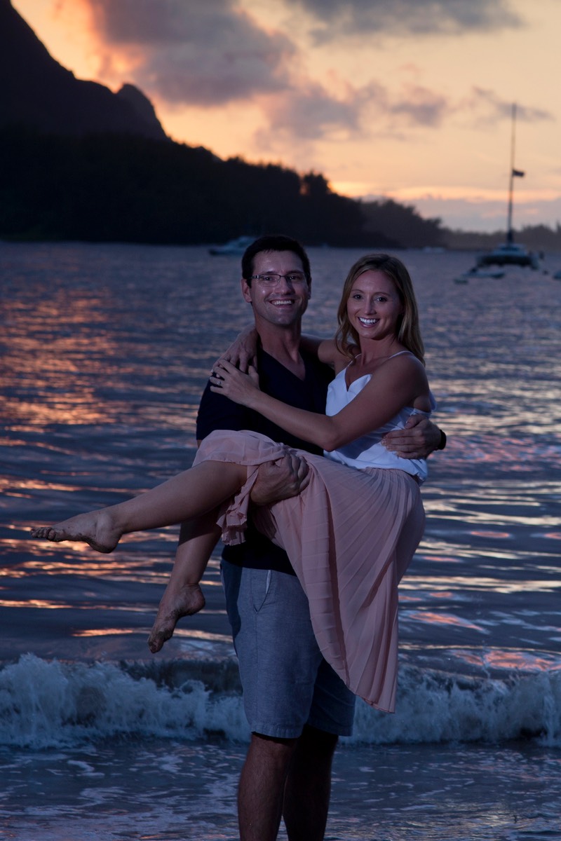 Kauai wedding photographer takes sunset shot with wedding couple