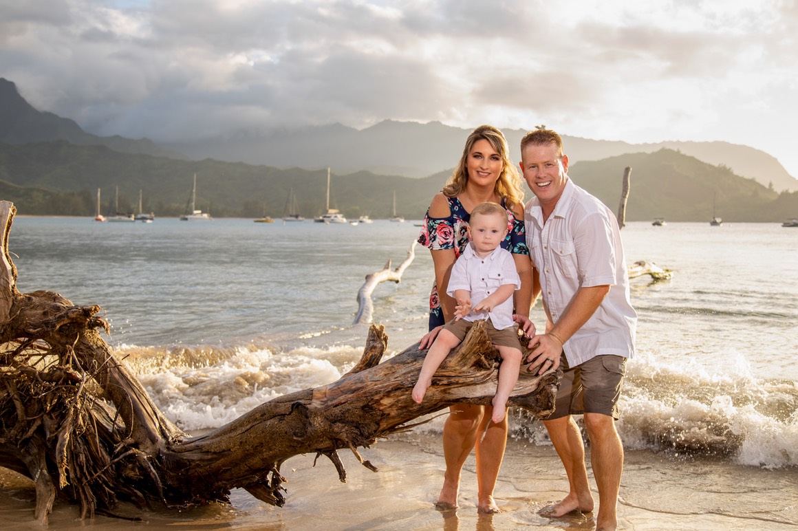 Mom, dad and toddler at Hanalei Bay summer in Kauai